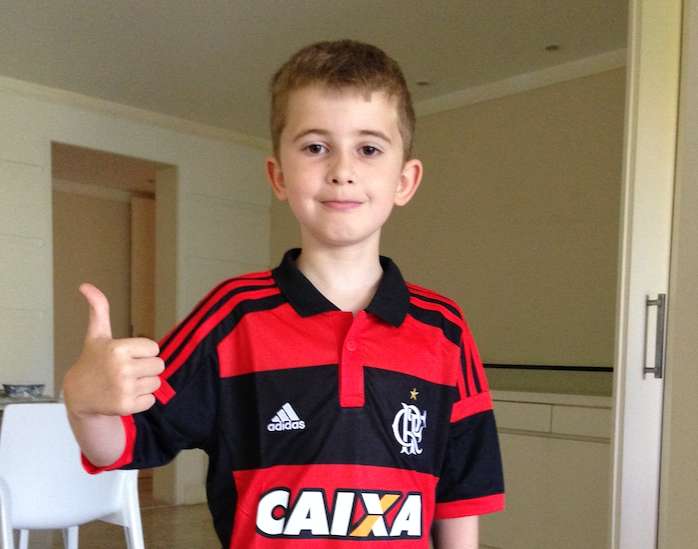 little boy wearing the jersey of Brazilian soccer team Flamengo
